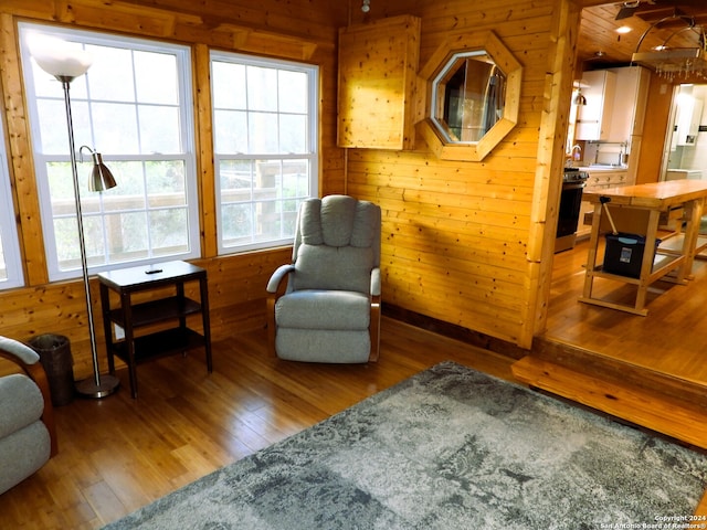 living area featuring wood walls and wood-type flooring