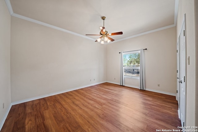 empty room with hardwood / wood-style floors, crown molding, and ceiling fan