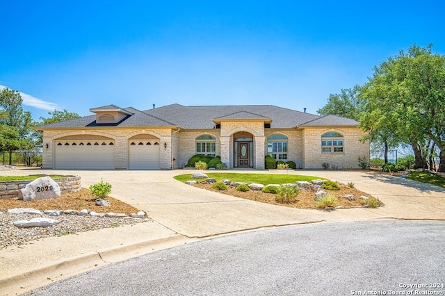 view of front of property with a front yard and a garage