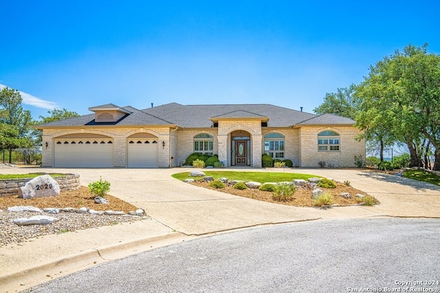 2029 Crown Rdg, Kerrville, TX 78028 - view of front of property with concrete driveway, a shingled roof, brick siding, and a garage