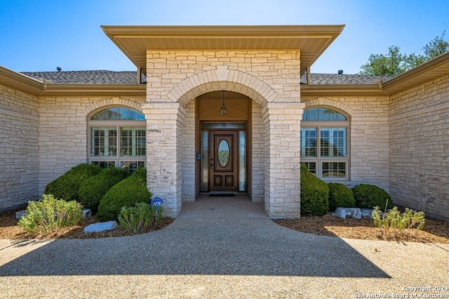 2029 Crown Rdg, Kerrville, TX 78028 - property entrance featuring a shingled roof and brick siding
