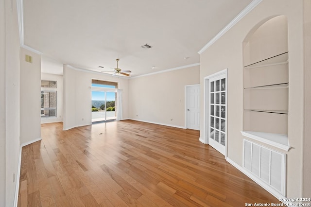 empty room with light hardwood / wood-style flooring, ceiling fan, and crown molding