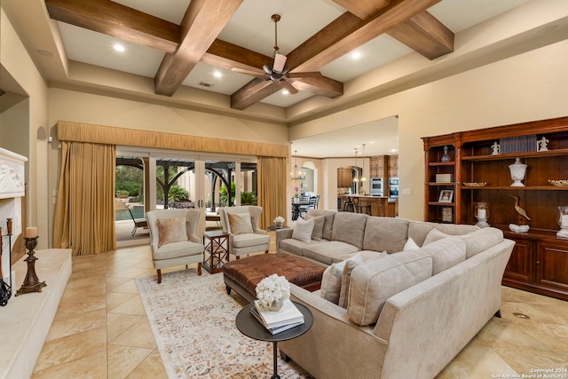 living room featuring visible vents, coffered ceiling, a ceiling fan, beamed ceiling, and a high ceiling