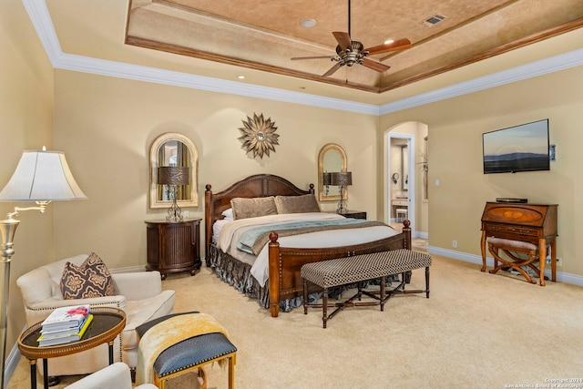 bedroom featuring arched walkways, ornamental molding, light carpet, and a raised ceiling