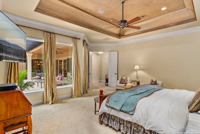 carpeted bedroom with a tray ceiling, visible vents, crown molding, and baseboards