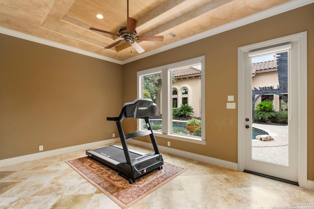 workout room featuring visible vents, a ceiling fan, baseboards, ornamental molding, and a raised ceiling