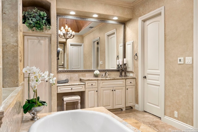 bathroom featuring ornamental molding, a bathtub, a chandelier, and vanity