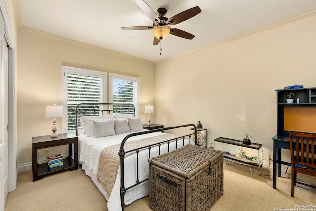 carpeted bedroom featuring ceiling fan, baseboards, and crown molding