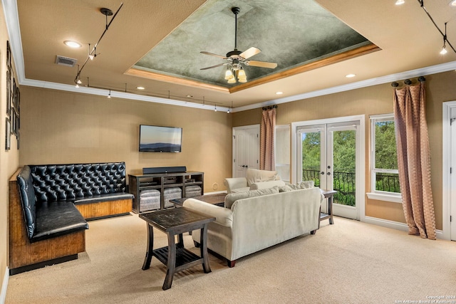 living area featuring carpet floors, visible vents, french doors, a tray ceiling, and crown molding