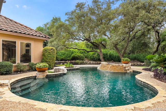 pool featuring an in ground hot tub