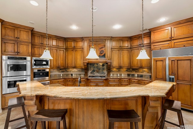 kitchen featuring tasteful backsplash, a breakfast bar area, brown cabinets, and built in appliances