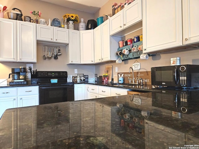 kitchen featuring white cabinets, black appliances, sink, and dark stone counters