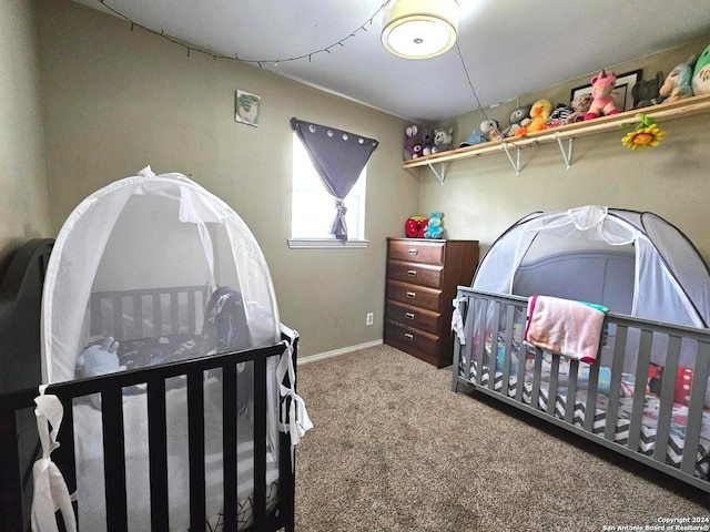 carpeted bedroom with a nursery area