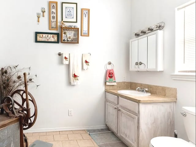 bathroom with vanity, toilet, and tile patterned floors