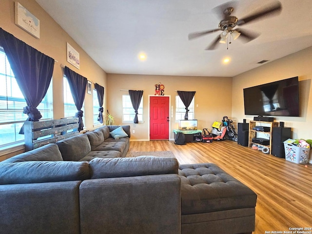 living room featuring ceiling fan and light hardwood / wood-style flooring