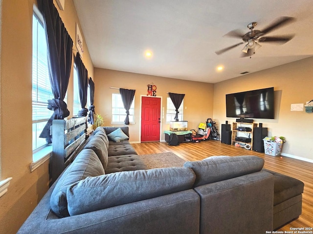 living room with wood-type flooring and ceiling fan