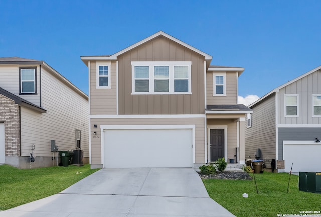 view of front of home with a front yard and a garage