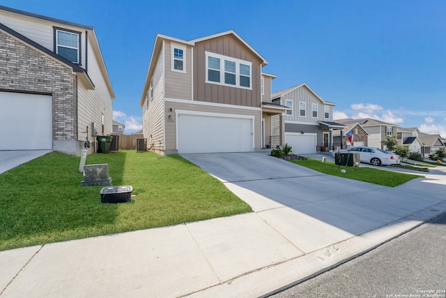 view of front of house with a garage, cooling unit, and a front lawn