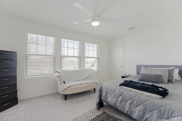 bedroom with light carpet and ceiling fan