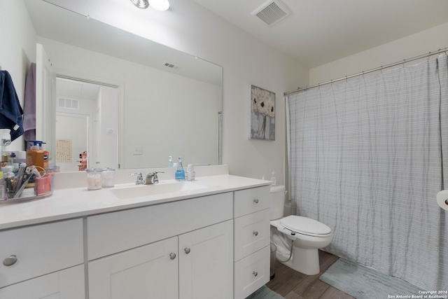 bathroom with vanity, walk in shower, hardwood / wood-style flooring, and toilet