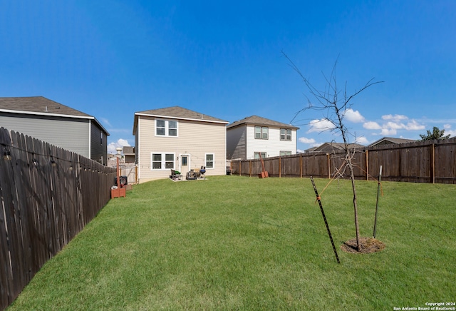 rear view of house with a yard