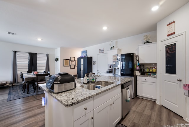 kitchen featuring white cabinetry, dishwasher, sink, and a center island with sink