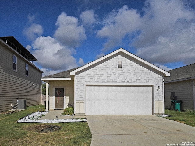 view of front of property with cooling unit, a front lawn, and a garage