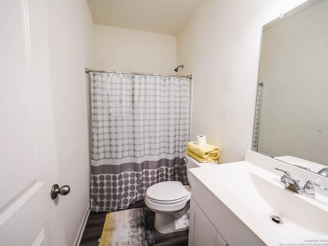 bathroom featuring vanity, toilet, hardwood / wood-style flooring, and walk in shower