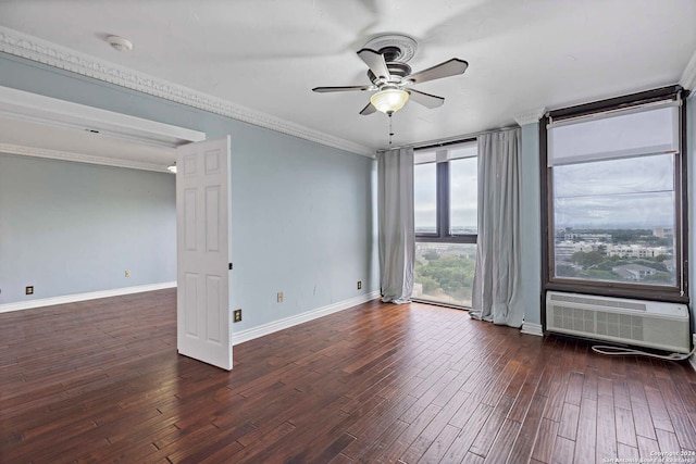 spare room with an AC wall unit, dark wood-type flooring, crown molding, and ceiling fan