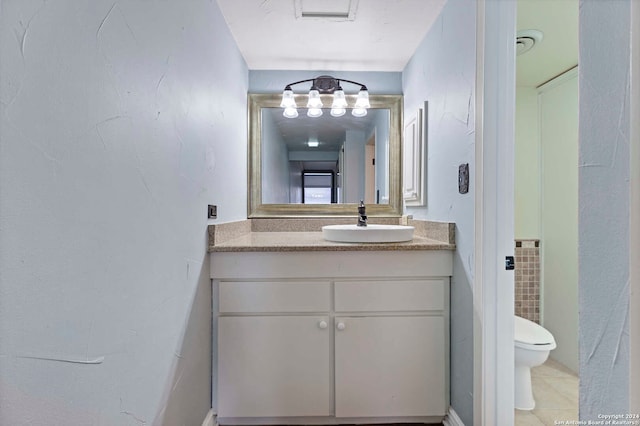 bathroom featuring vanity, toilet, and tile patterned floors