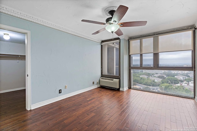 interior space with ceiling fan, dark hardwood / wood-style flooring, and a wall unit AC