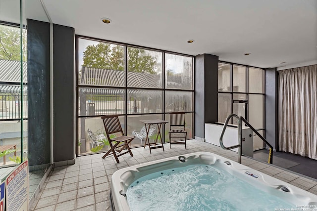 sunroom featuring a hot tub