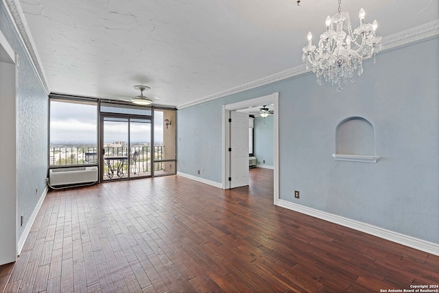 unfurnished room with ornamental molding, an AC wall unit, dark wood-type flooring, ceiling fan with notable chandelier, and a wall of windows