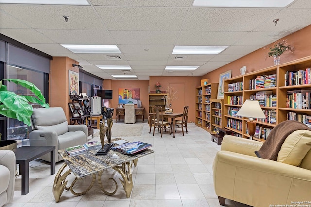 tiled living room with a drop ceiling