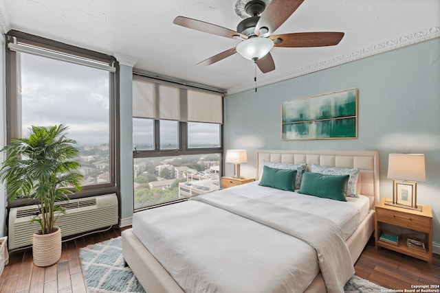 bedroom featuring dark wood-type flooring, multiple windows, and ceiling fan