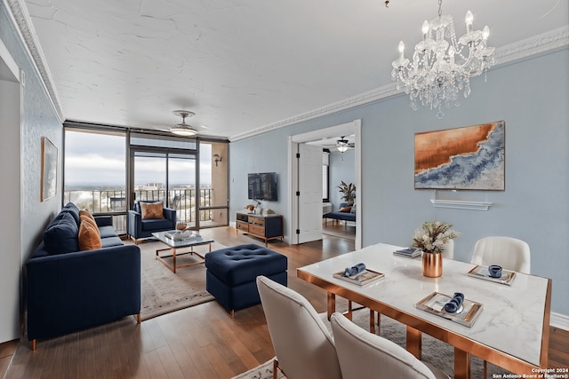 dining room featuring hardwood / wood-style flooring, ornamental molding, ceiling fan with notable chandelier, and floor to ceiling windows