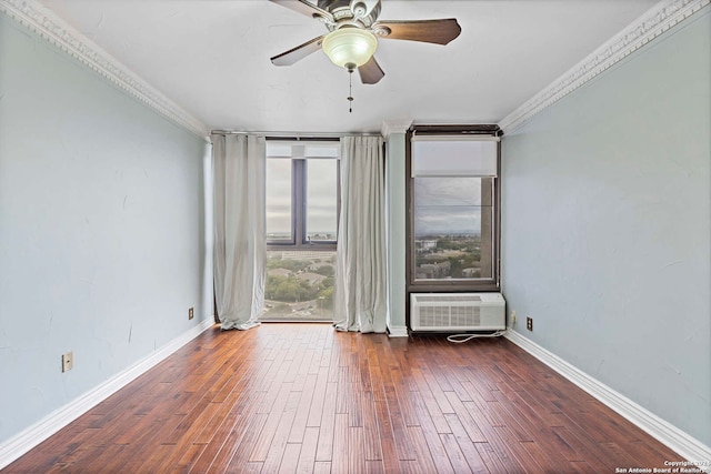 empty room featuring a wall unit AC, crown molding, dark hardwood / wood-style floors, and ceiling fan