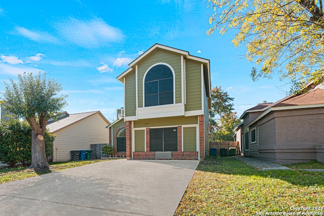 view of property featuring a front yard and a garage