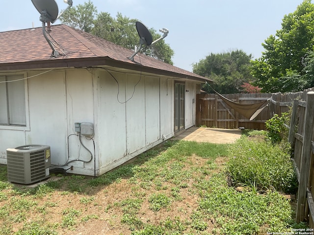 view of side of home featuring central AC