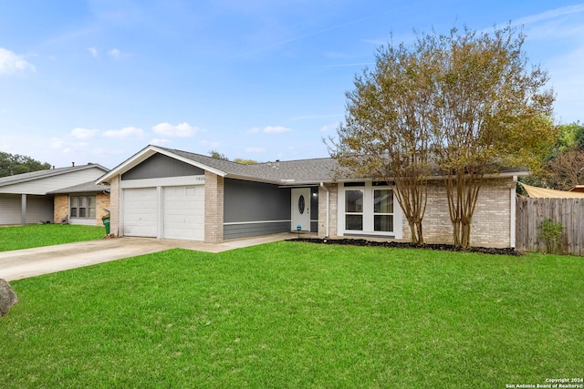 single story home featuring a garage and a front lawn