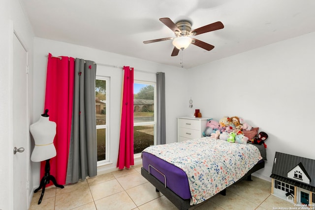 tiled bedroom featuring ceiling fan