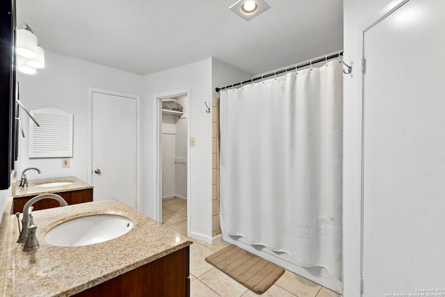 bathroom with tile patterned flooring, shower / bath combination with curtain, and vanity