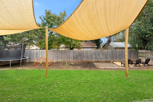 view of yard with a patio area and a trampoline