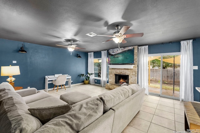 tiled living room with a textured ceiling and a brick fireplace