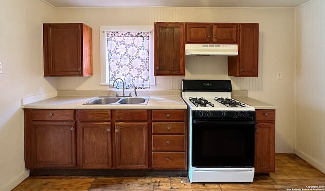 kitchen featuring white gas range and sink