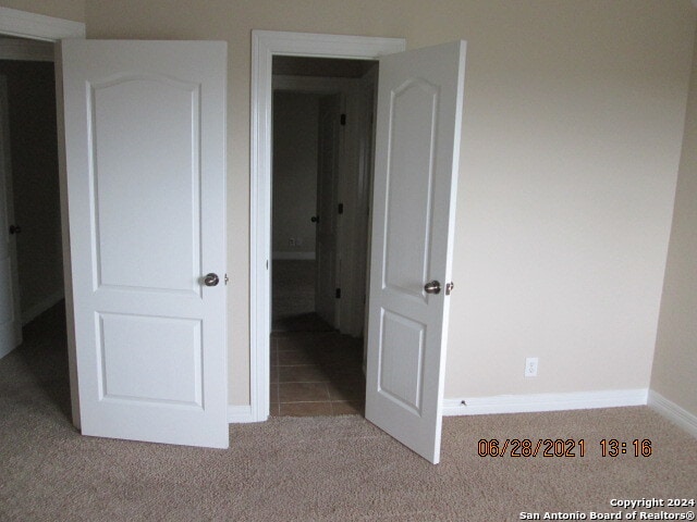 unfurnished bedroom featuring light colored carpet