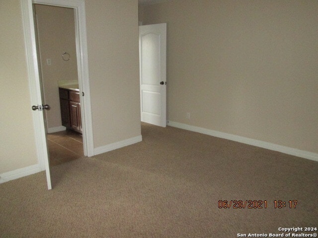 unfurnished bedroom with light colored carpet