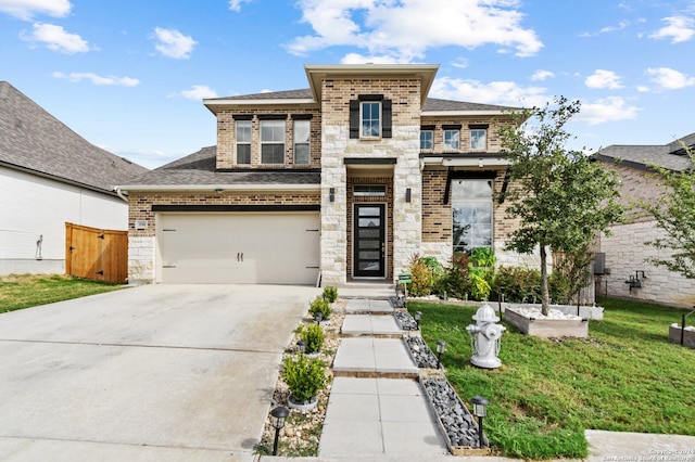 view of front of property featuring a front yard and a garage