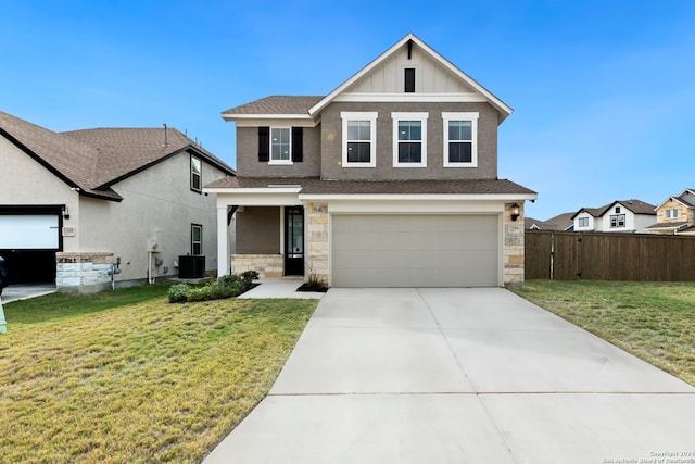 view of front of property featuring a garage, a front lawn, and central air condition unit