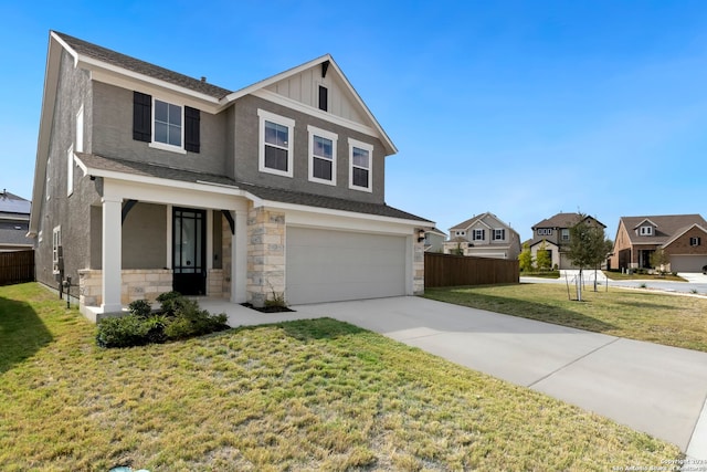 view of front of home featuring covered porch, a garage, and a front lawn